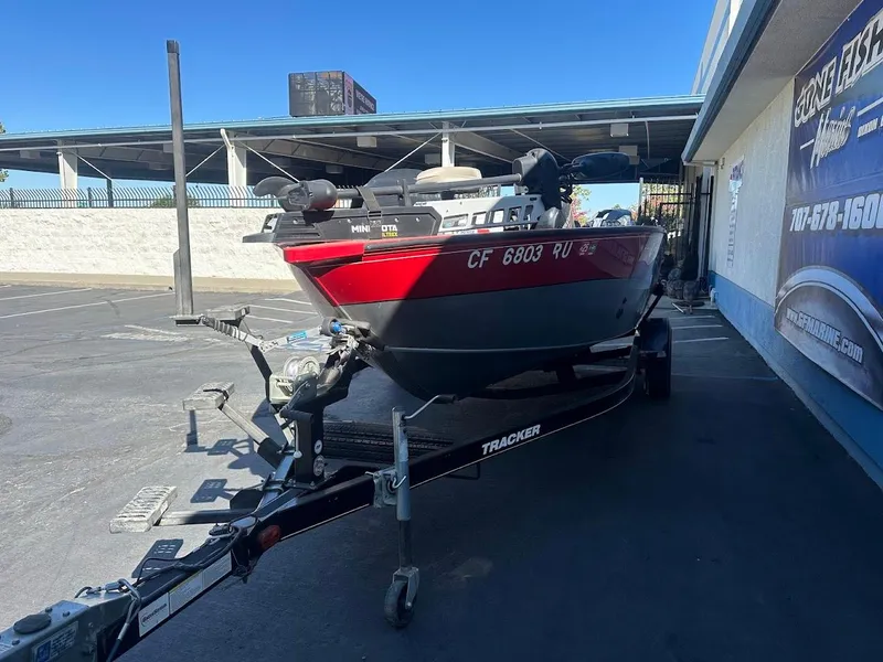 Slide: The Image of 2013 Tracker Pro Guide V-175 SC boat on trailer in parking lot. - 3