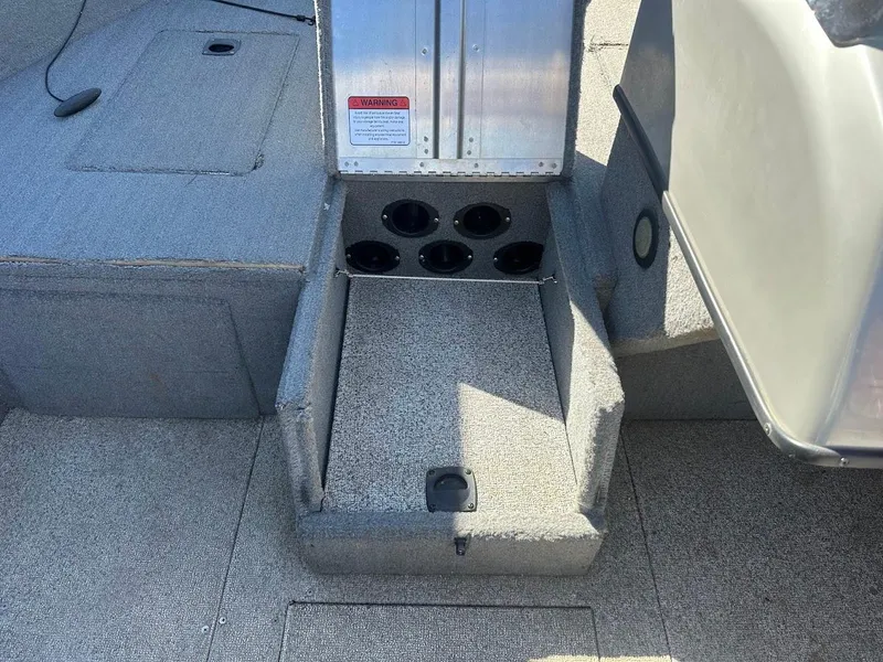 Slide: The Image of 2013 Tracker Pro Guide V-175 SC boat interior with cup holders and carpeted flooring. - 31