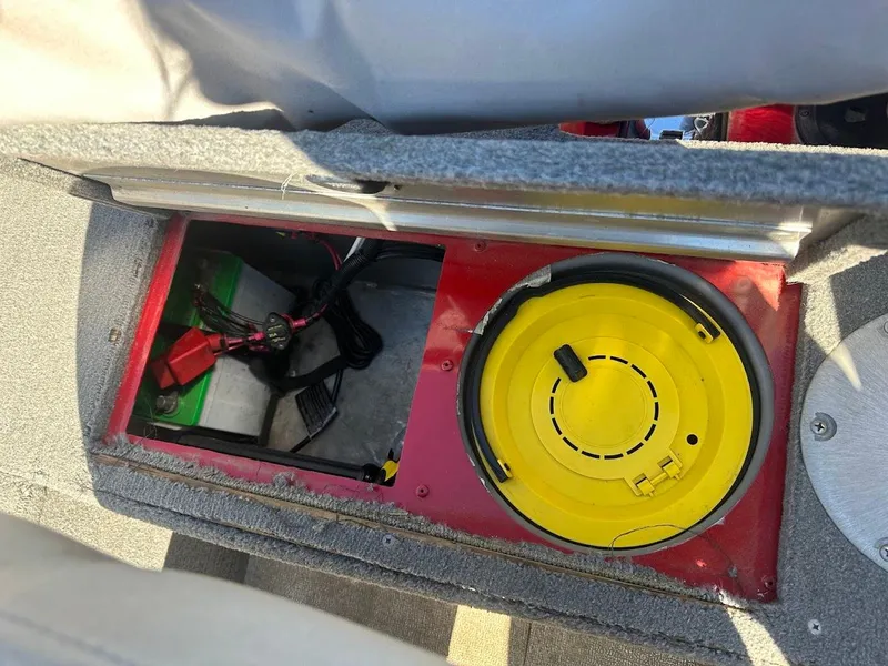 Slide: The Image of 2013 Tracker Pro Guide V-175 SC boat battery compartment with yellow lid and wiring. - 34