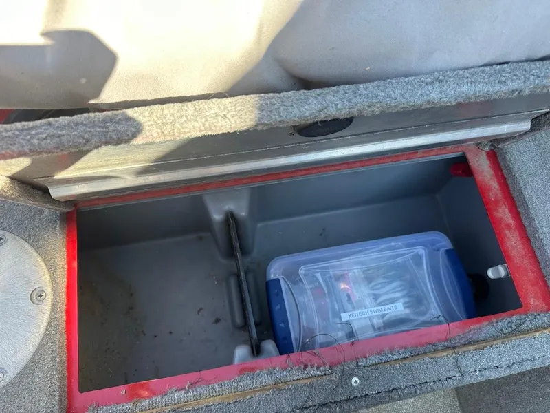 Slide: The Image of Storage compartment in a 2013 Tracker Pro Guide V-175 SC boat with fishing gear. - 35