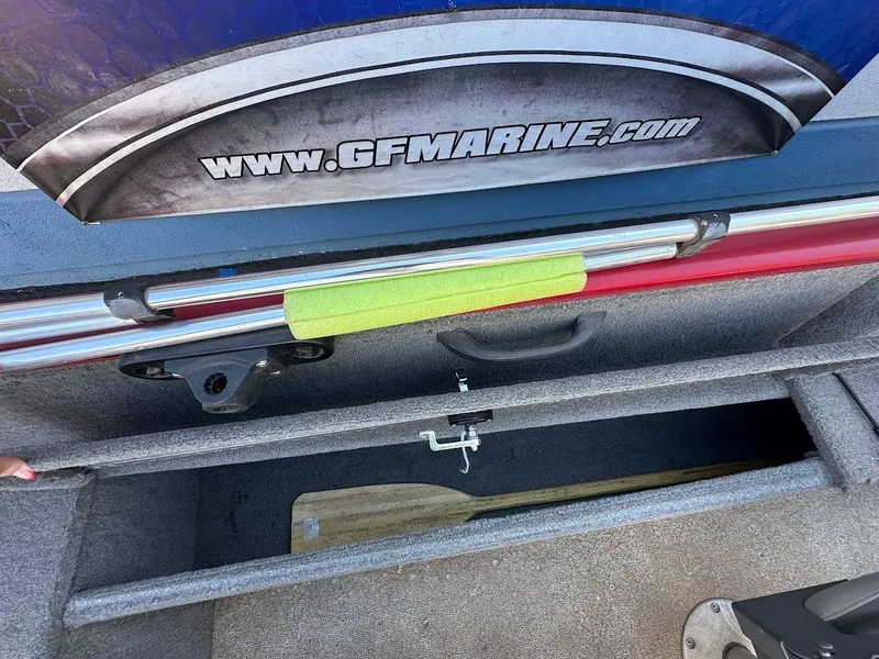 Slide: The Image of Storage compartment of 2013 Tracker Pro Guide V-175 SC boat with paddle and accessories. - 36