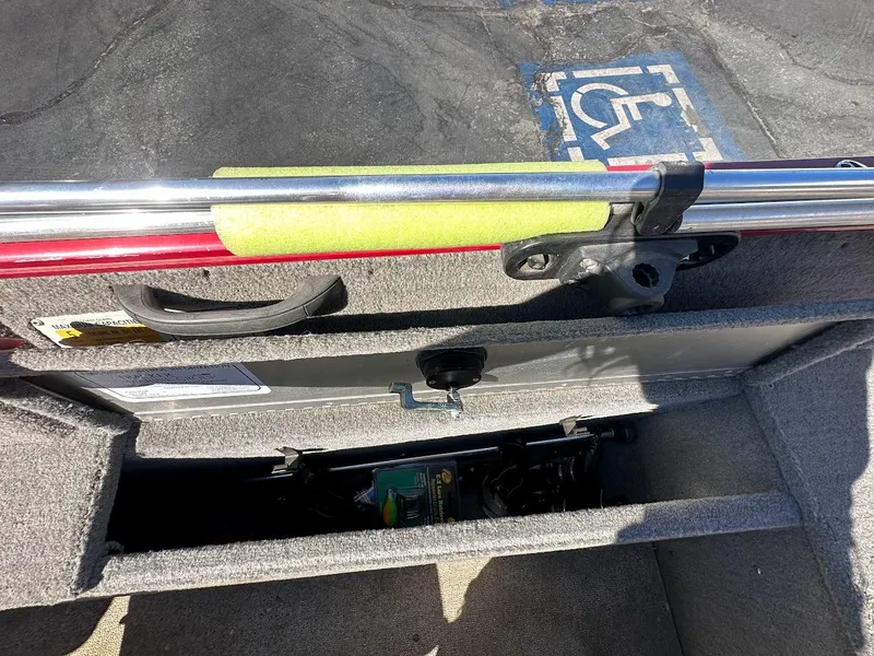 Slide: The Image of 2013 Tracker Pro Guide V-175 SC boat interior storage compartment with fishing rod holder. - 37