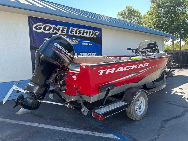 Slide: The Image of 2013 Tracker Pro Guide V-175 SC boat with Mercury engine, parked outdoors. - 8