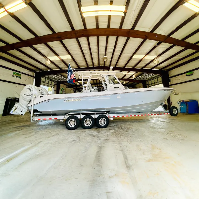 The Image of 2022 Everglades 365 Center Console boat on trailer in warehouse setting. - 0