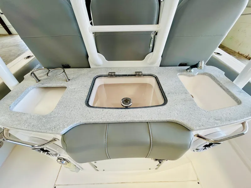 Slide: The Image of 2022 Everglades 365 Center Console boat interior with sink and cup holders. - 12
