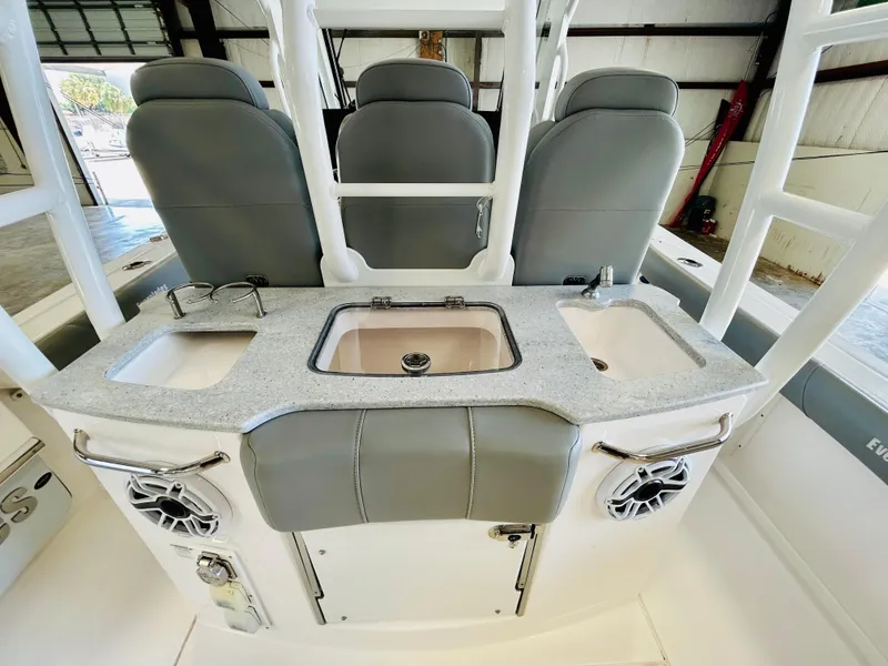 Slide: The Image of 2022 Everglades 365 Center Console interior with seating and sink area. - 14