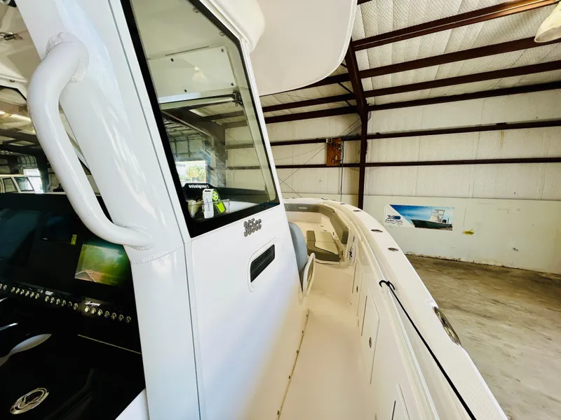 Slide: The Image of 2022 Everglades 365 Center Console boat in a warehouse, showcasing sleek design and spacious deck. - 18