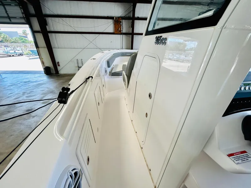 Slide: The Image of 2022 Everglades 365 Center Console boat interior in a warehouse setting. - 19