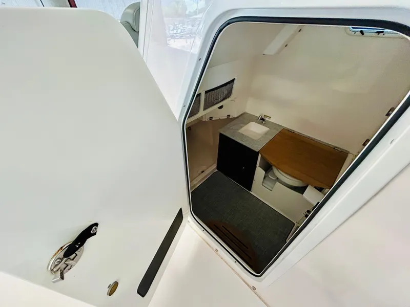 Slide: The Image of 2022 Everglades 365 Center Console interior cabin with sink and toilet. - 20