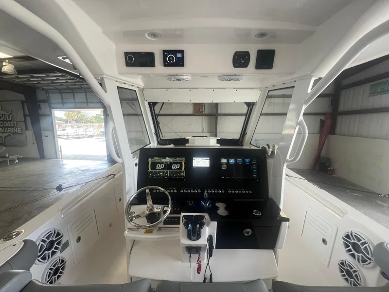 Slide: The Image of 2022 Everglades 365 Center Console boat interior with advanced navigation system and sleek design. - 21
