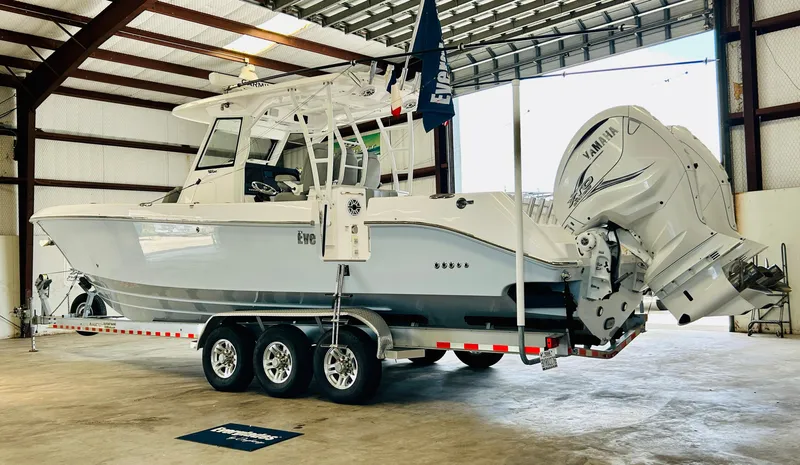 Slide: The Image of 2022 Everglades 365 Center Console boat with Yamaha engines in a warehouse. - 7