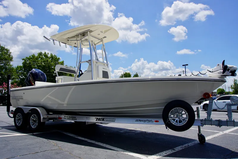 Slide: The Image of 2026 Pathfinder 2200 TRS boat on trailer under blue sky with clouds. - 2