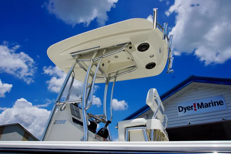 Slide: The Image of 2026 Pathfinder 2200 TRS boat at Dyer Marine under a blue sky. - 4
