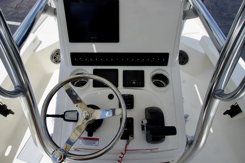 Slide: The Image of 2026 Pathfinder 2200 TRS boat console with steering wheel and electronic controls. - 7