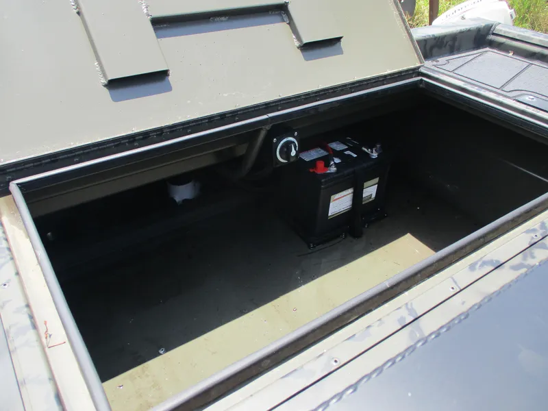 Slide: The Image of Open storage compartment of 2024 Gator Tail 1860 Extreme CC boat with battery inside. - 11