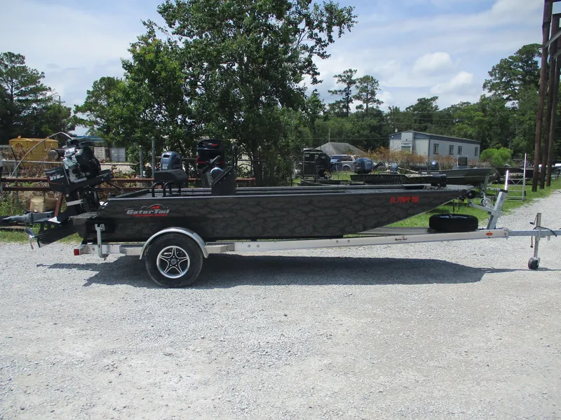 Slide: The Image of 2024 Gator Tail 1860 Extreme CC boat on trailer, parked outdoors. - 2