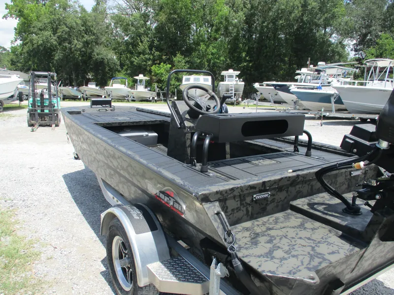 Slide: The Image of 2024 Gator Tail 1860 Extreme CC boat in a marina, surrounded by other vessels. - 3