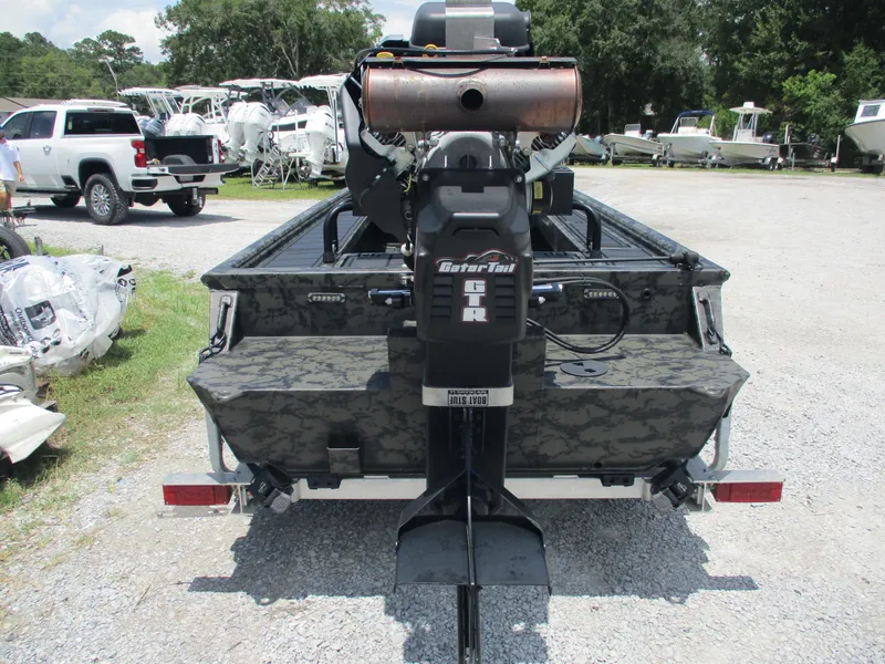 Slide: The Image of 2024 Gator Tail 1860 Extreme CC boat with powerful motor, parked outdoors. - 4
