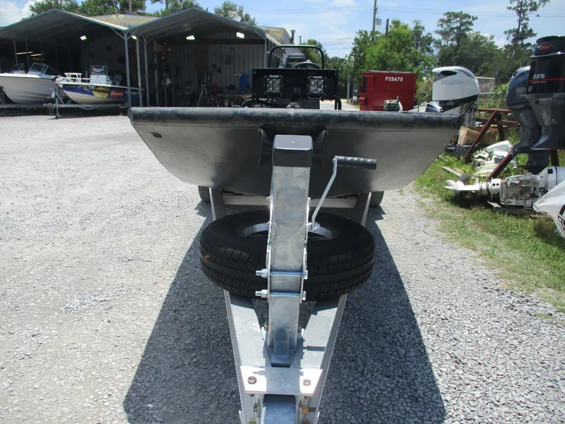 Slide: The Image of 2024 Gator Tail 1860 Extreme CC boat on trailer, parked in a gravel lot. - 6
