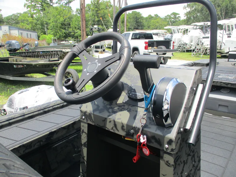 Slide: The Image of 2024 Gator Tail 1860 Extreme CC boat console with steering wheel and controls. - 8