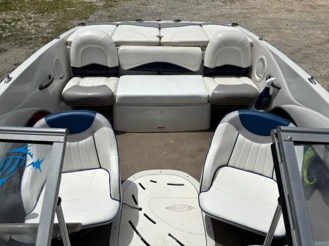 Slide: The Image of 2006 Tahoe Q4 Sport Fish boat interior with white and blue seating. - 11