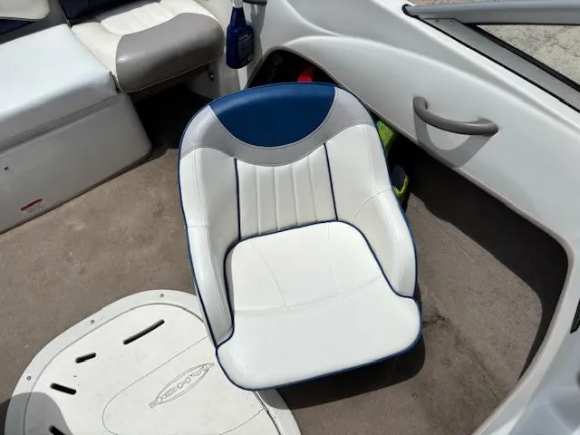 Slide: The Image of 2006 Tahoe Q4 Sport Fish boat interior with white and blue seating. - 12