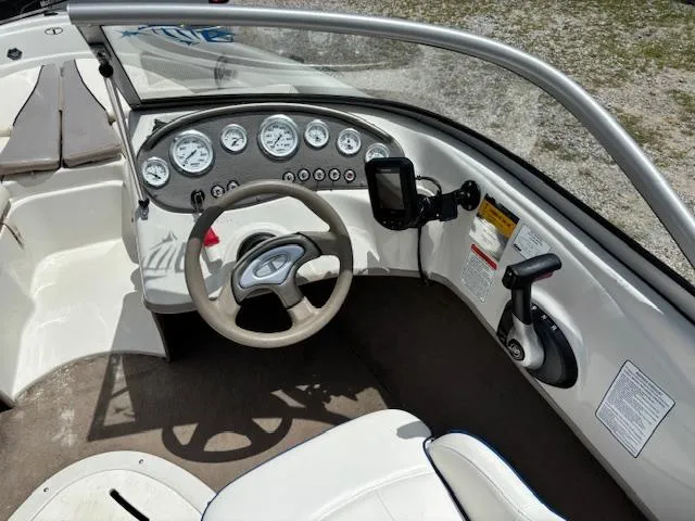 Slide: The Image of 2006 Tahoe Q4 Sport Fish boat dashboard with steering wheel and gauges. - 14