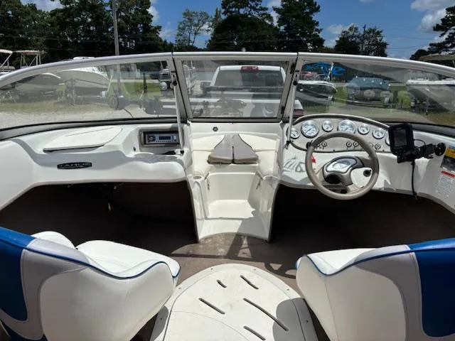 Slide: The Image of 2006 Tahoe Q4 Sport Fish boat interior with steering wheel, dashboard, and seating. - 15