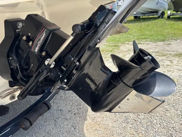 Slide: The Image of 2006 Tahoe Q4 Sport Fish boat with MerCruiser outboard motor, parked on gravel. - 19