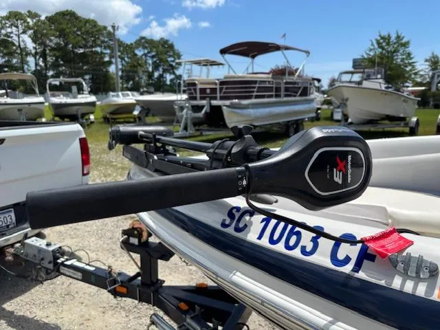 Slide: The Image of 2006 Tahoe Q4 Sport Fish boat with trolling motor, parked on trailer in marina. - 21
