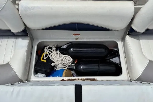 Slide: The Image of Storage compartment in a 2006 Tahoe Q4 Sport Fish boat with ropes and fenders. - 25