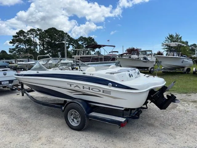 Slide: The Image of 2006 Tahoe Q4 Sport Fish boat on trailer, parked outdoors under blue sky. - 3