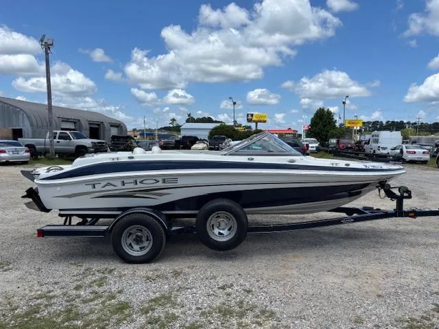 Slide: The Image of 2006 Tahoe Q4 Sport Fish boat on trailer under blue sky with clouds. - 6
