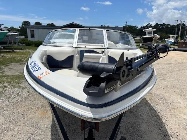 Slide: The Image of 2006 Tahoe Q4 Sport Fish boat with trolling motor, parked outdoors on gravel. - 8