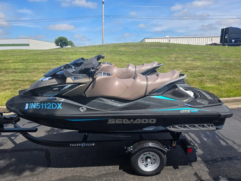 The Image of 2016 Sea-Doo GTX Limited iS 260 jet ski on trailer, parked outdoors. - 0