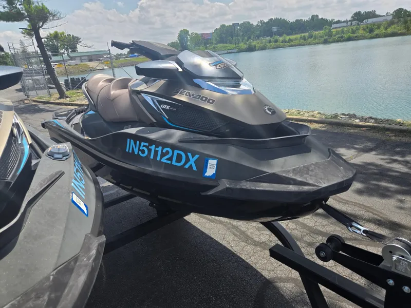 Slide: The Image of 2016 Sea-Doo GTX Limited iS 260 jet ski on trailer by a lake. - 5