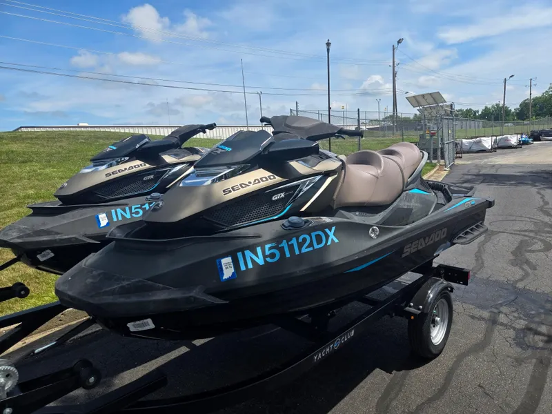 Slide: The Image of 2016 Sea-Doo GTX Limited iS 260 jet skis on trailers, parked outdoors. - 8