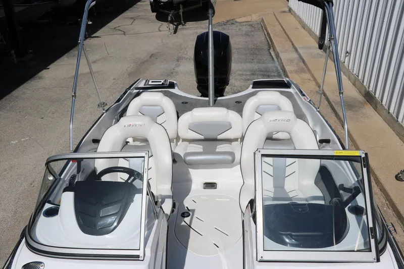 Slide: The Image of 2017 Nitro Z19 Sport boat interior with white seating and dual consoles. - 14