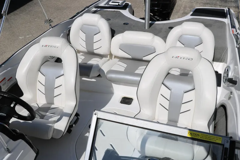 Slide: The Image of 2017 Nitro Z19 Sport boat interior with white cushioned seats and steering wheel. - 15