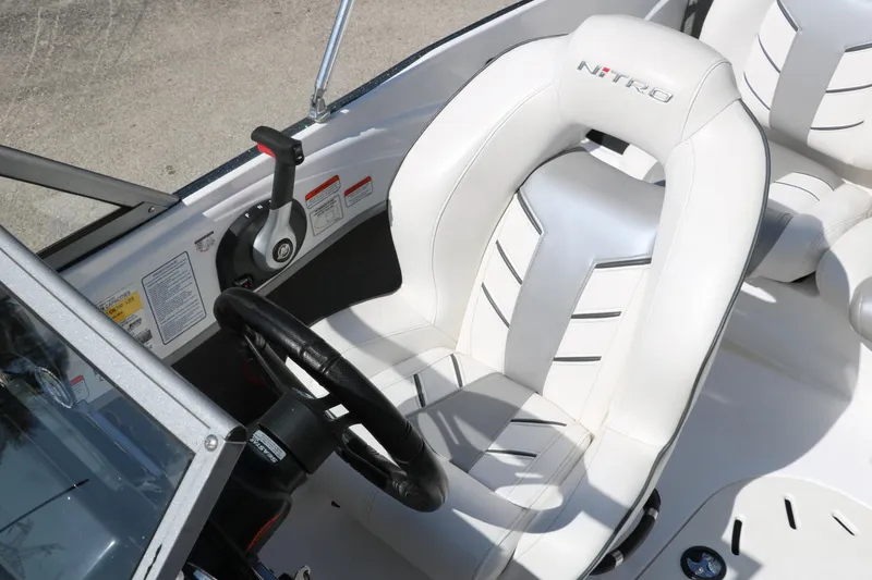 Slide: The Image of 2017 Nitro Z19 Sport boat interior with steering wheel and white seat. - 18