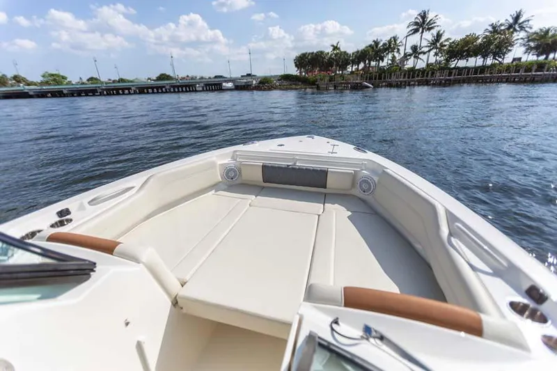 Slide: The Image of Manufacturer Provided Image: 2023 Cobia 240 Dual Console boat on water, spacious seating, scenic view. - 3