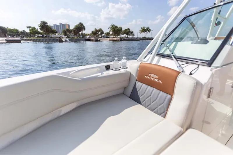 Slide: The Image of Manufacturer Provided Image: 2023 Cobia 240 Dual Console boat interior with waterfront view. - 4