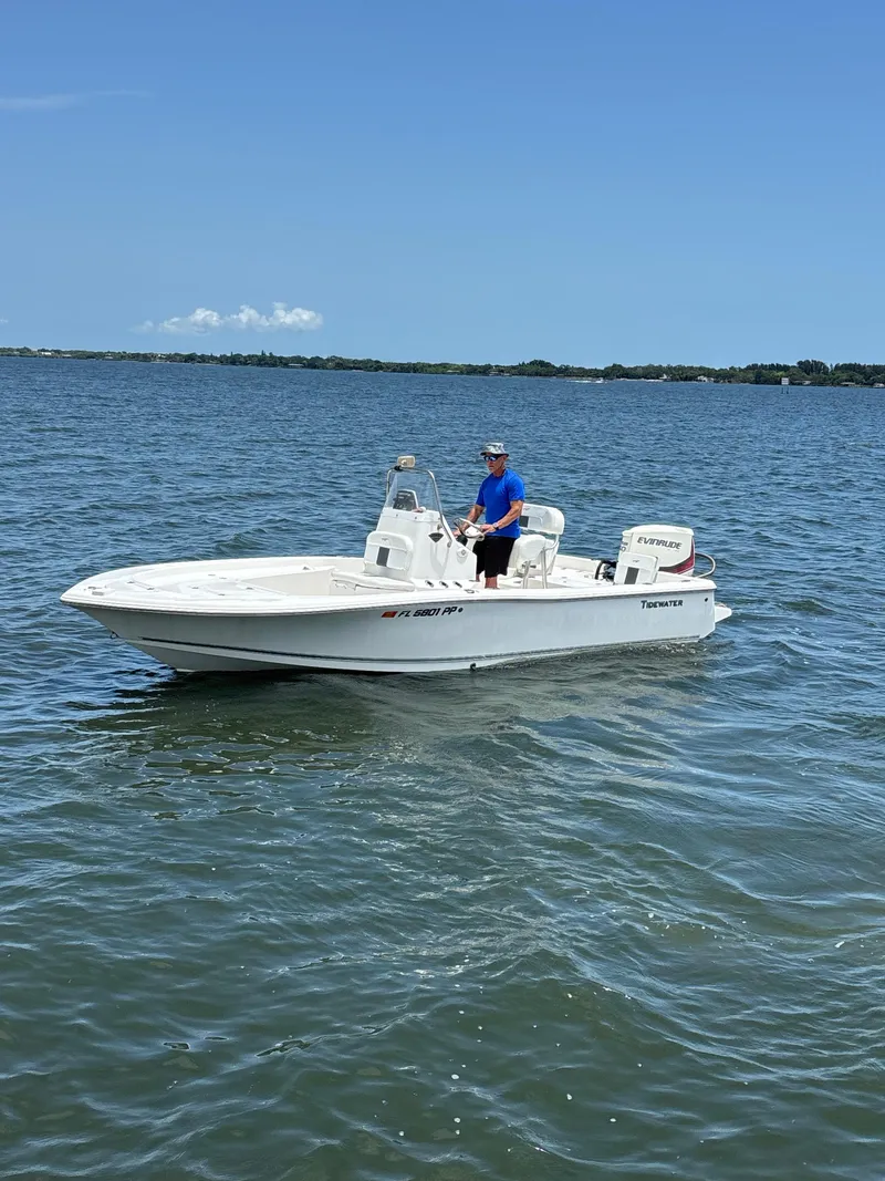 Slide: The Image of 2014 Tidewater 2000 Carolina Bay boat on calm water, clear sky background. - 3
