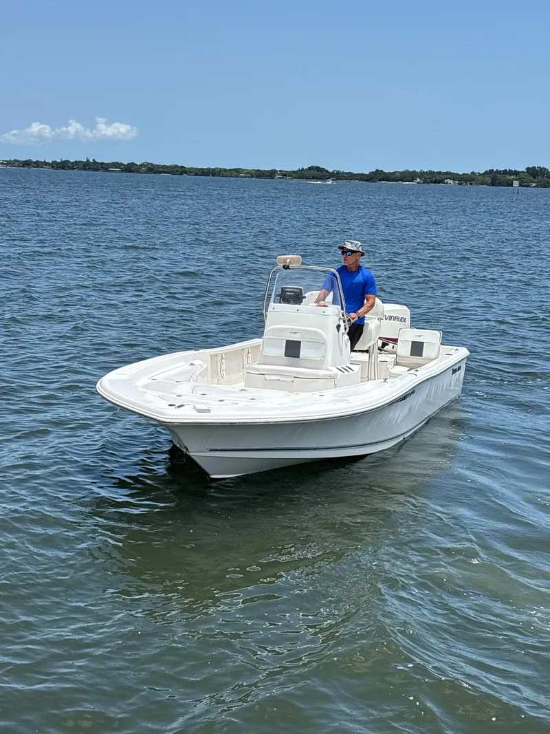Slide: The Image of 2014 Tidewater 2000 Carolina Bay boat on calm water, clear sky background. - 5