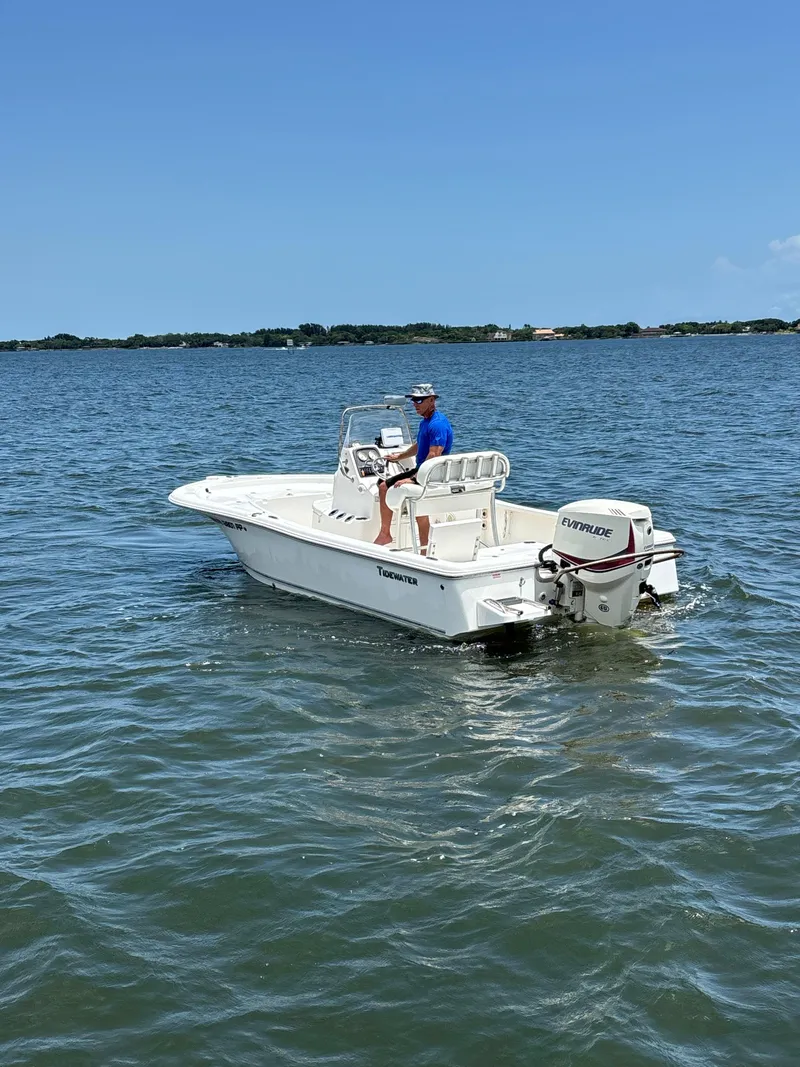 Slide: The Image of 2014 Tidewater 2000 Carolina Bay boat on calm water, clear sky background. - 7