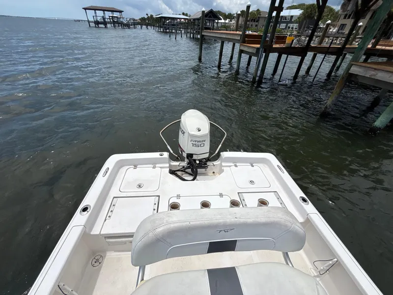 Slide: The Image of 2014 Tidewater 2000 Carolina Bay boat with Evinrude 150 engine on a calm waterfront. - 8