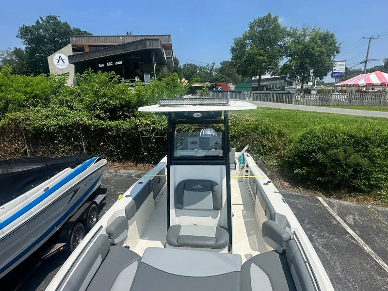 Slide: The Image of 2023 NauticStar 251 Hybrid boat interior with open storage compartments and seating. - 10