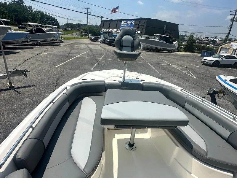 Slide: The Image of 2023 NauticStar 251 Hybrid boat storage compartment with open hatch and visible wiring. - 12