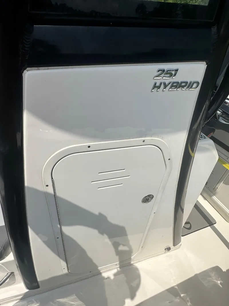 Slide: The Image of 2023 NauticStar 251 Hybrid boat interior with built-in toilet compartment. - 13