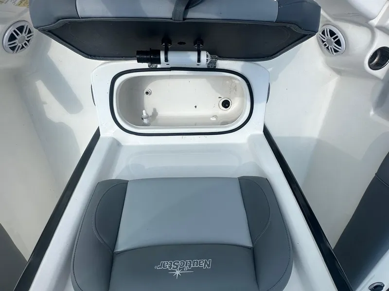 Slide: The Image of 2023 NauticStar 251 Hybrid boat with an open compartment showing a toilet. - 14
